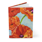 Red poppy hardcover journal standing slightly open, showing the cover and white page edges